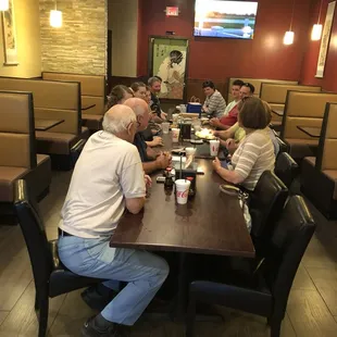 a group of people sitting at a table