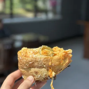 a hand holding a pastry