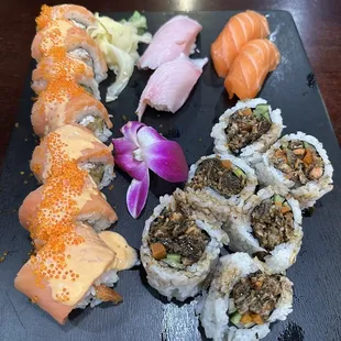 Orange Lady Roll, Sake nigiri, Hamachi nigiri, and salmon skin roll