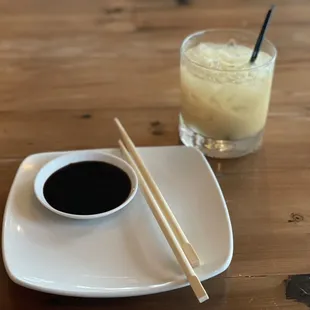 a drink and chopsticks on a plate