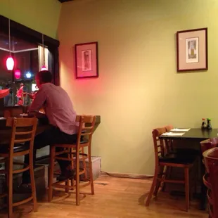 a man sitting at a bar in a restaurant