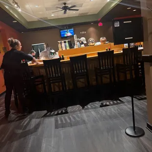 a man standing at a counter in a restaurant