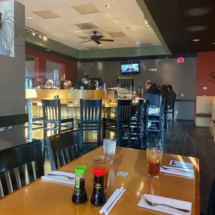 a view of a dining room with tables and chairs