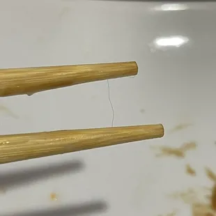 chopsticks stuck in a bowl of food