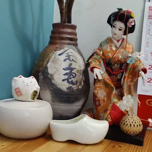 a picture of a geisha doll next to a calendar