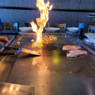 a man cooking on a grill