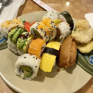 a plate of sushi and rolls