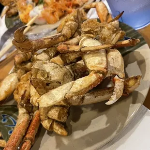 a plate of crab legs and other food items