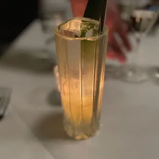 a close up of a glass of water with a knife sticking out of it