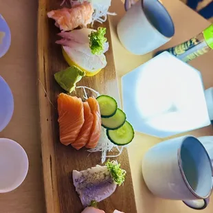 a long wooden platter of sushi