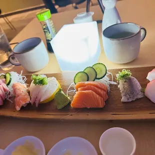 a wooden platter of sushi