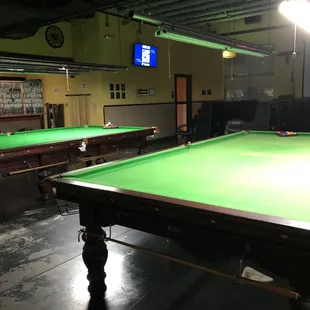 a pool table with a green cloth