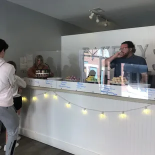 a man and a woman at a cake shop