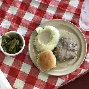Our smothered pork chops with green beans, mashed potatoes, and a warm roll!