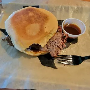 Sliced Brisket sandwich with sauce.
