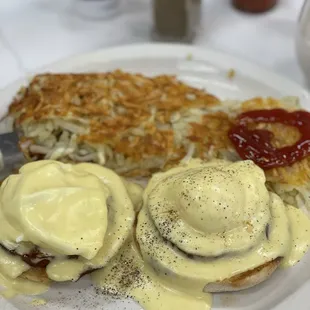 Eggs Benedict with hash browns.