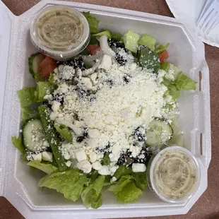 a salad in a styrofoam container