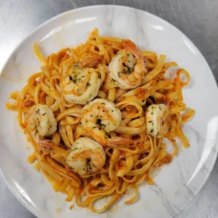 a plate of pasta with shrimp