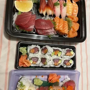 two trays of different types of sushi