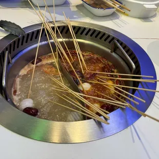 Hot pot with assorted skewers