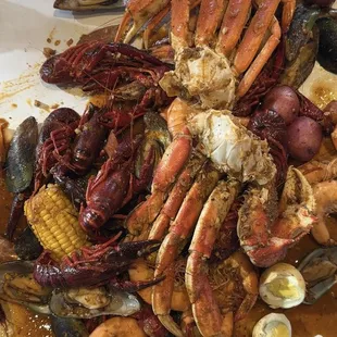 Seafood boil with crab, mussels, crawfish, shrimp, eggs, potatoes, corn and sausage.