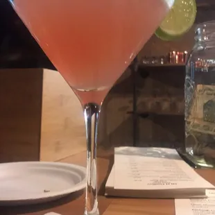 a pink cocktail in a coupe glass