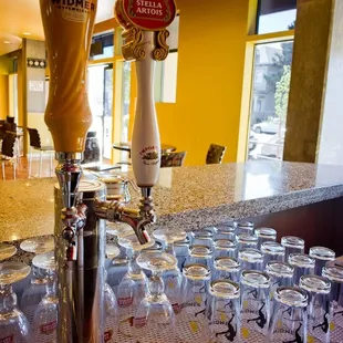 a bar with beer taps and glasses