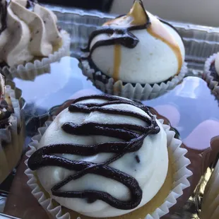 a variety of frosted cupcakes