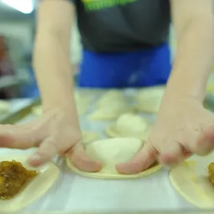 a person preparing food on a tray