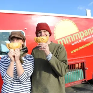 a man and a woman eating donuts