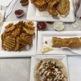 Cod fish tacos, one piece of halibut, catfish dinner and a side of waffle fries
