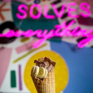 a hand holding an ice cream cone