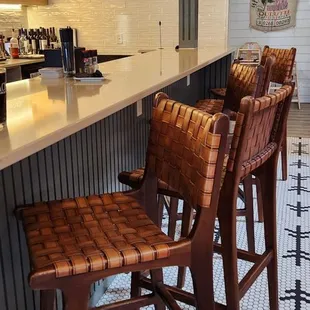 a kitchen with a bar and stools