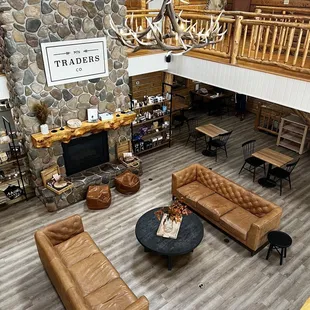 a living room with a stone fireplace