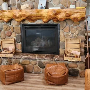 a living room with a stone fireplace