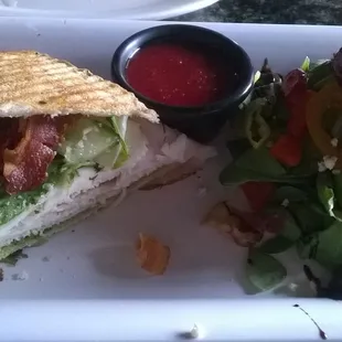 Half turkey-bacon sandwich with mini spinach salad