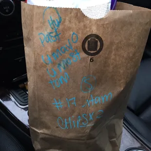 a brown paper bag filled with food