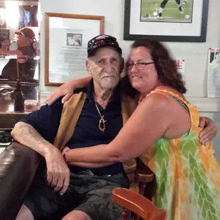 a man and woman sitting at a bar