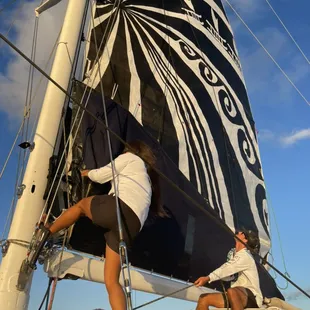 Crew hoisting the main sail