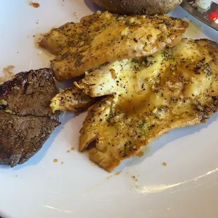 Lemmon pepper chicken, baked potatoe and a piece of sirloin steak