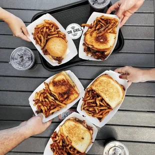 a group of people holding trays of food