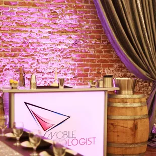 Here&apos;s one of our original portable bars lit up beautifully in front of the exposed brick of The Century Event &amp; Wedding Venue.