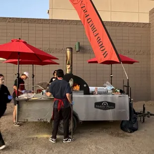 a group of people standing under umbrellas