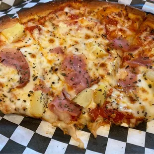 Hawaiian pizza on cauliflower crust, half eaten