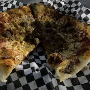 a half eaten pizza in a basket