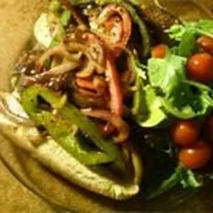 Vegan Italian Sausage with peppers and onions on a vegan bun