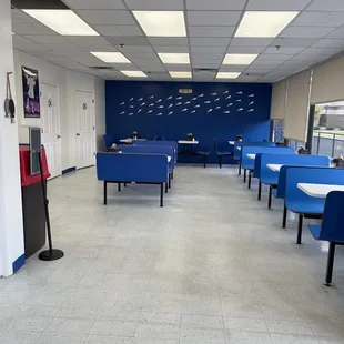 a large room with blue chairs