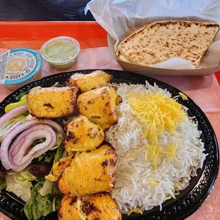 Joojeh (chicken breast) kabob, rice, salad, and naan.
