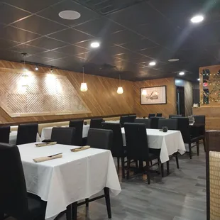 a dining area with tables and chairs