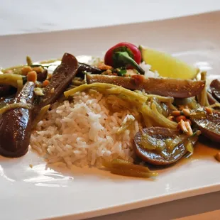 Local eggplant with green curry, coconut rice and thai peanut gremolata at cafe nola